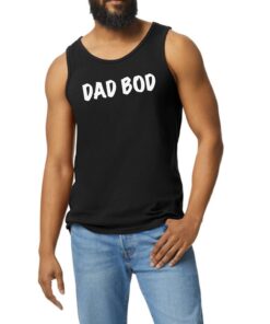 A man with a beard and jeans is wearing a black tank top.