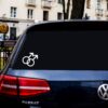 A car with a sticker of two male symbols on it.