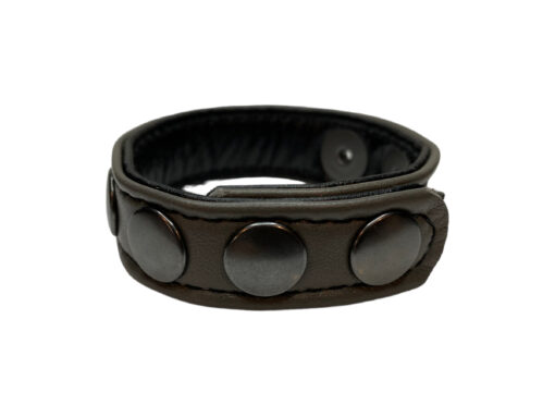 A black leather bracelet with three metal buttons.